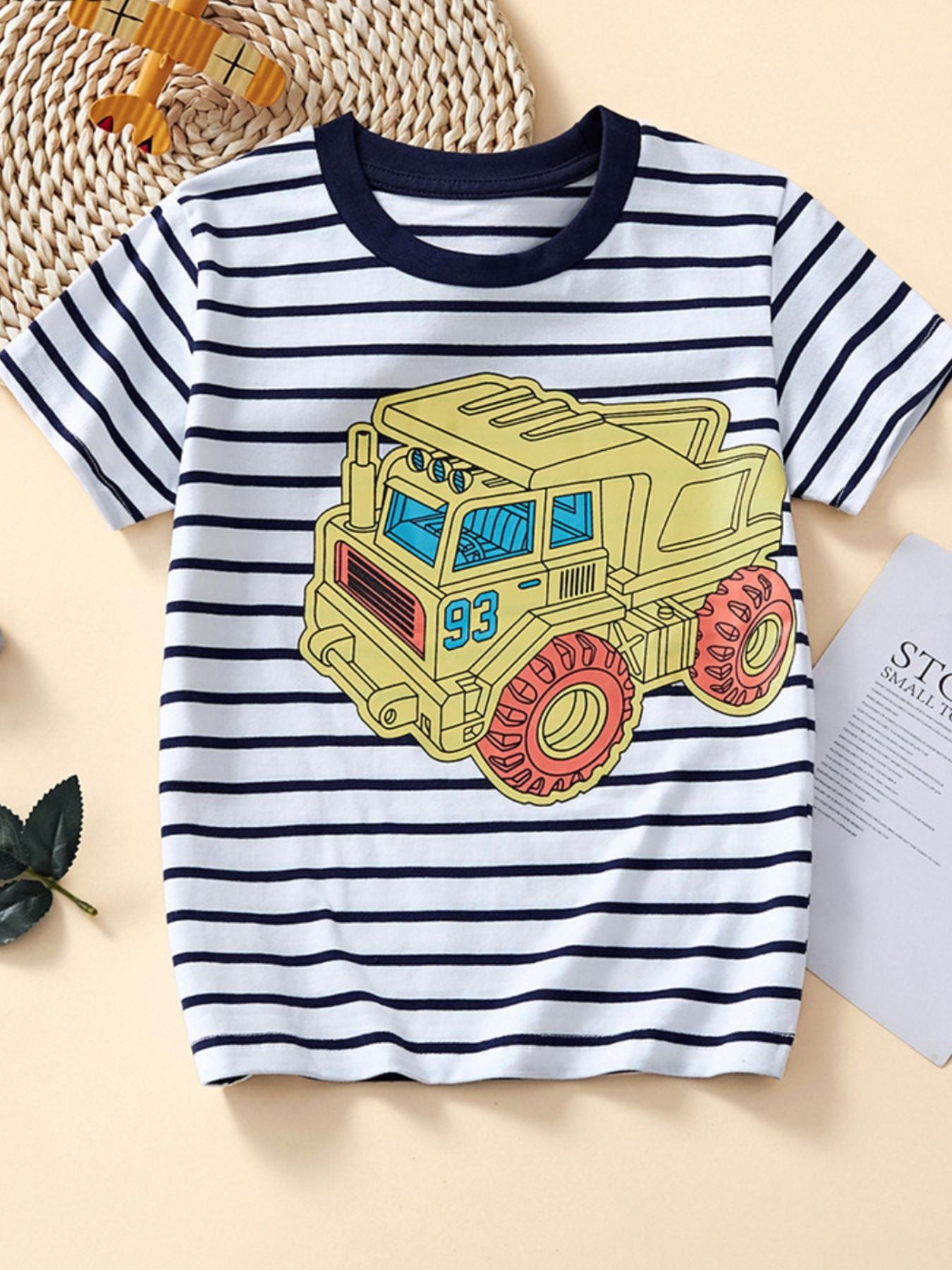 White and navy striped children's crew neck T-shirt with a large yellow dump truck graphic
