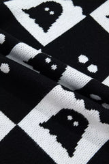 Close up of black and white ghost checkerboard knit fabric in a fold