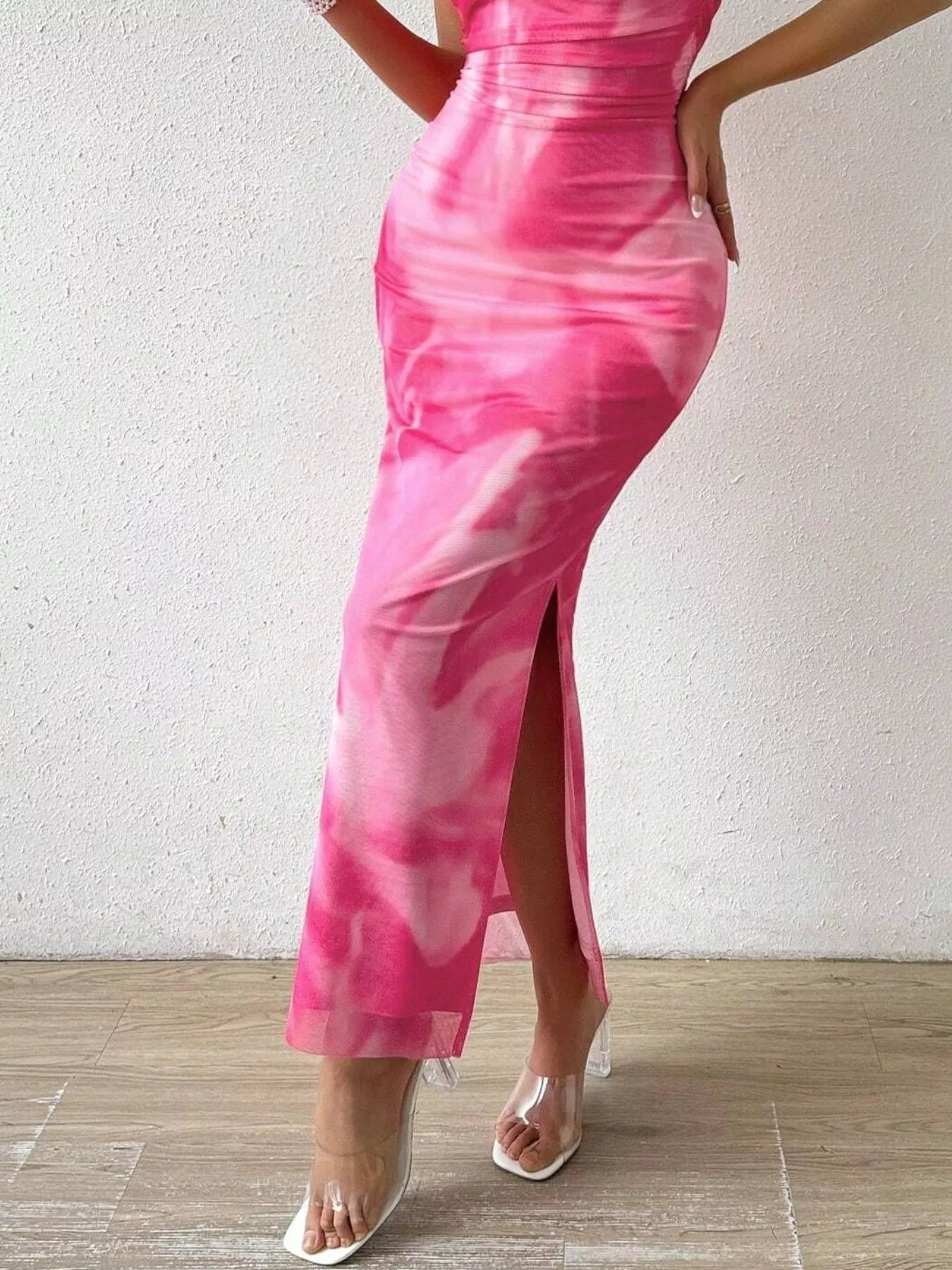 Detail view of fuchsia pink tie dye ruched bodycon tube slit dress lower skirt