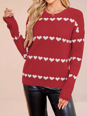 On-model front view of a red dropped shoulder sweater with rows of white hearts
