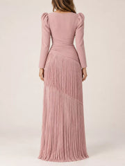 Pink long sleeve midi dress with tiered fringe skirt, back full view on model