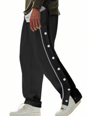 Men's black loose-fit track pants with side snap buttons and pockets.
