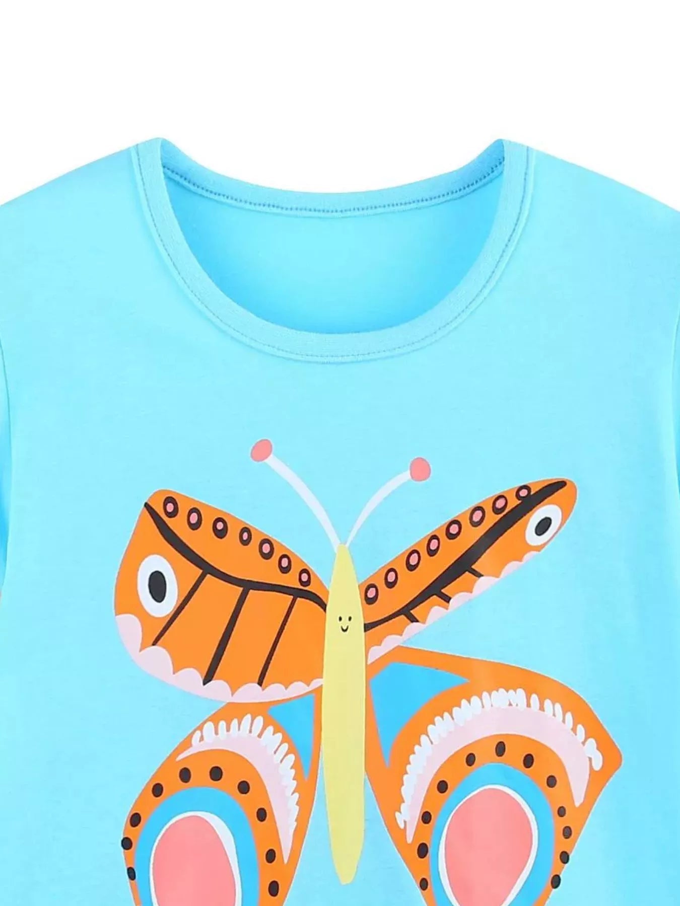 Close-up of the pastel blue children's t-shirt neckline above an orange butterfly