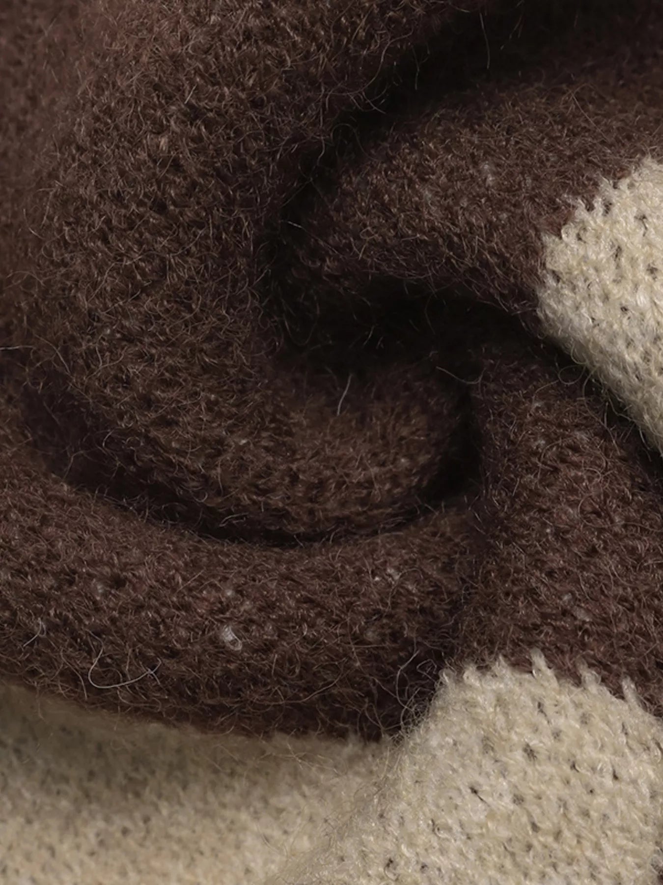 Close-up of the soft brown and beige argyle knit fabric texture