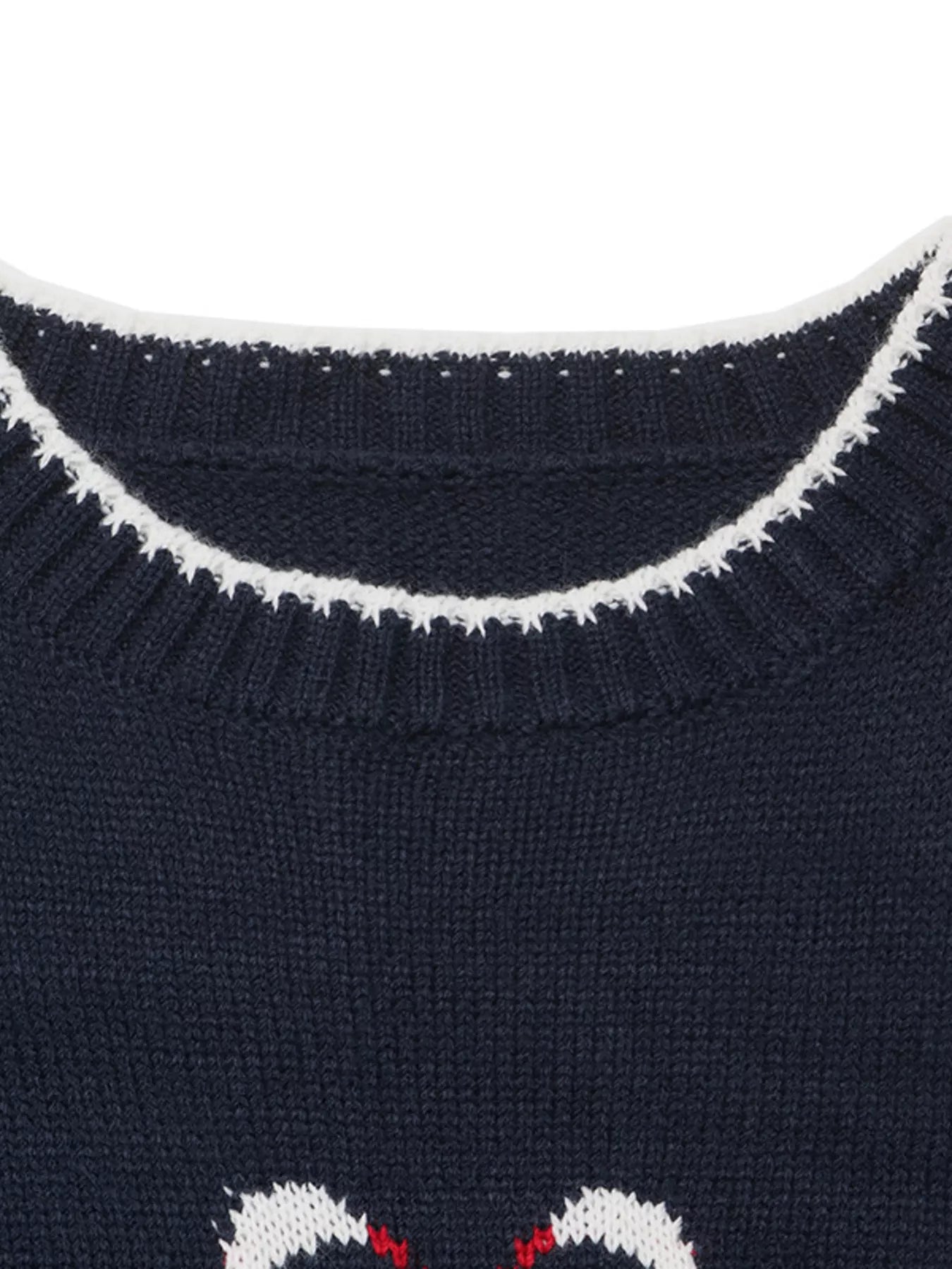Close up of a navy ribbed neckline with white trim and swan motif below