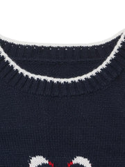 Close up of a navy ribbed neckline with white trim and swan motif below