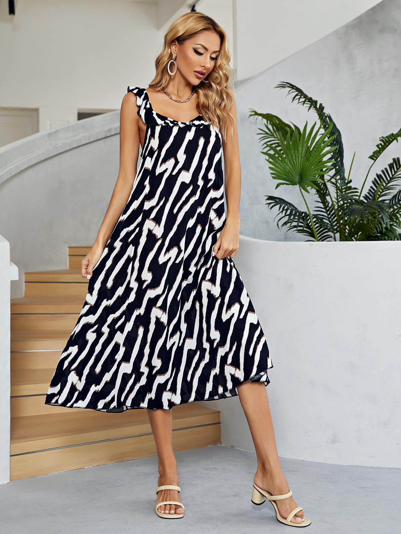 Women's black and white two-tone midi dress with a low back and V-neck.