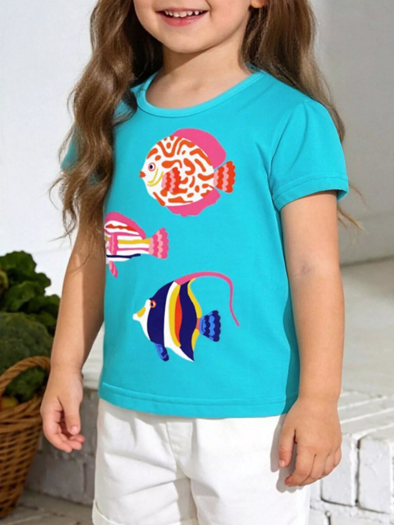 Children's aqua cotton T-shirt with a fish print and short sleeves.