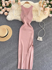 Pink sleeveless knit bodycon midi dress, front view with side slit on hanger