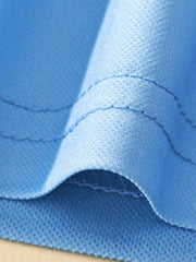 Close-up of the sky blue polo fabric fold showing texture and double stitching