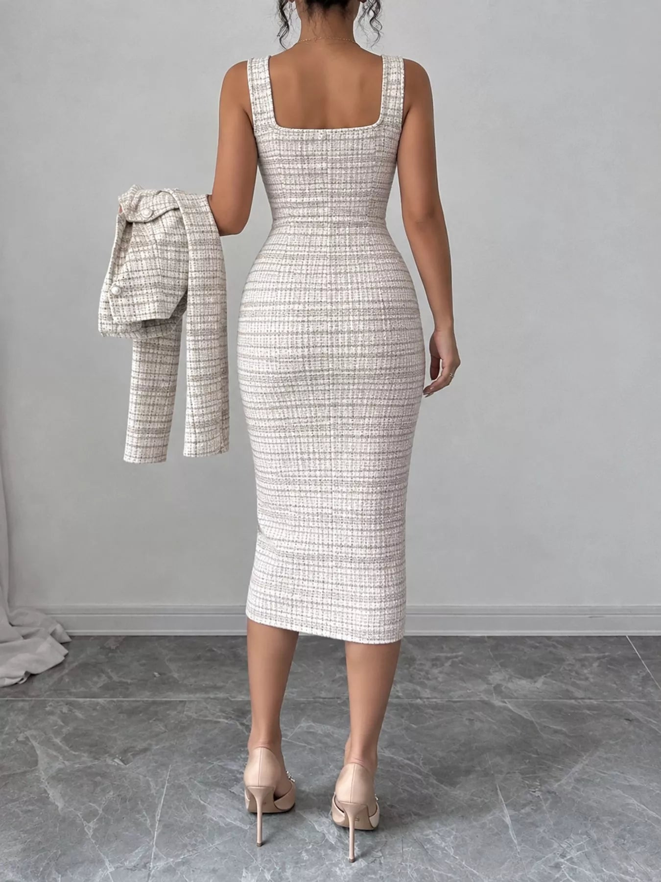 Back view of khaki tweed square neck dress held with the matching cardigan in hand