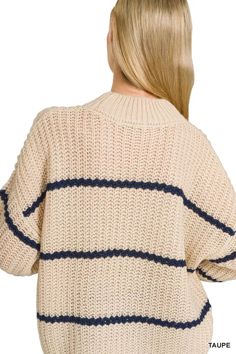 Close back view of cream oversize striped sweater showing knit texture and stripes