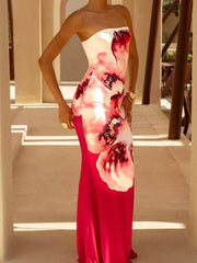 Model wearing strapless white and red floral tube maxi dress, front view outdoors