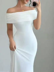 Close up mirror selfie of model wearing white off shoulder bodycon maxi dress with ruched band