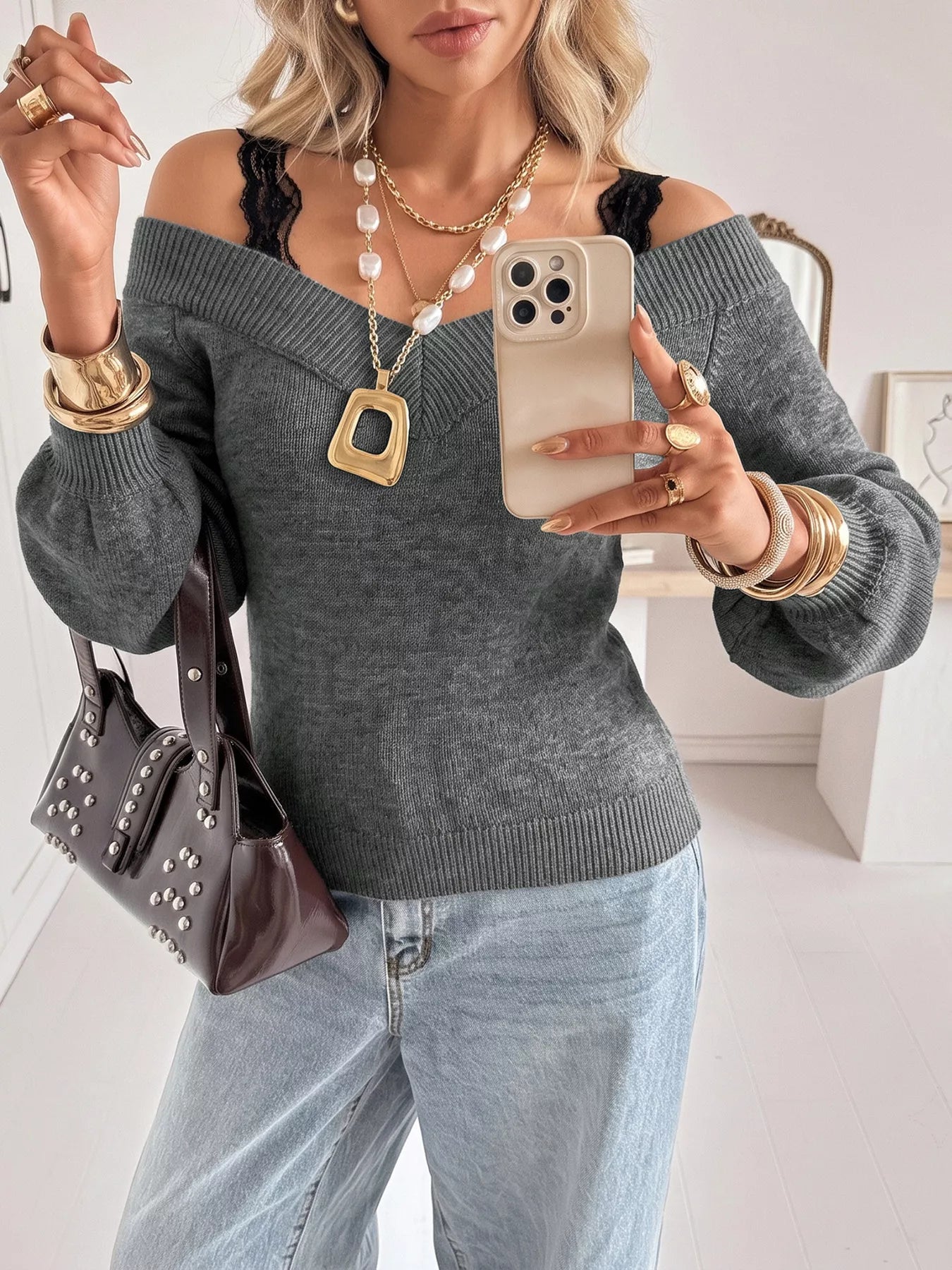 Mirror selfie of dark grey off shoulder lace trim sweater with light jeans