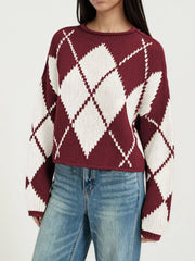 On-model front view of a burgundy and cream argyle knit sweater with dropped shoulders