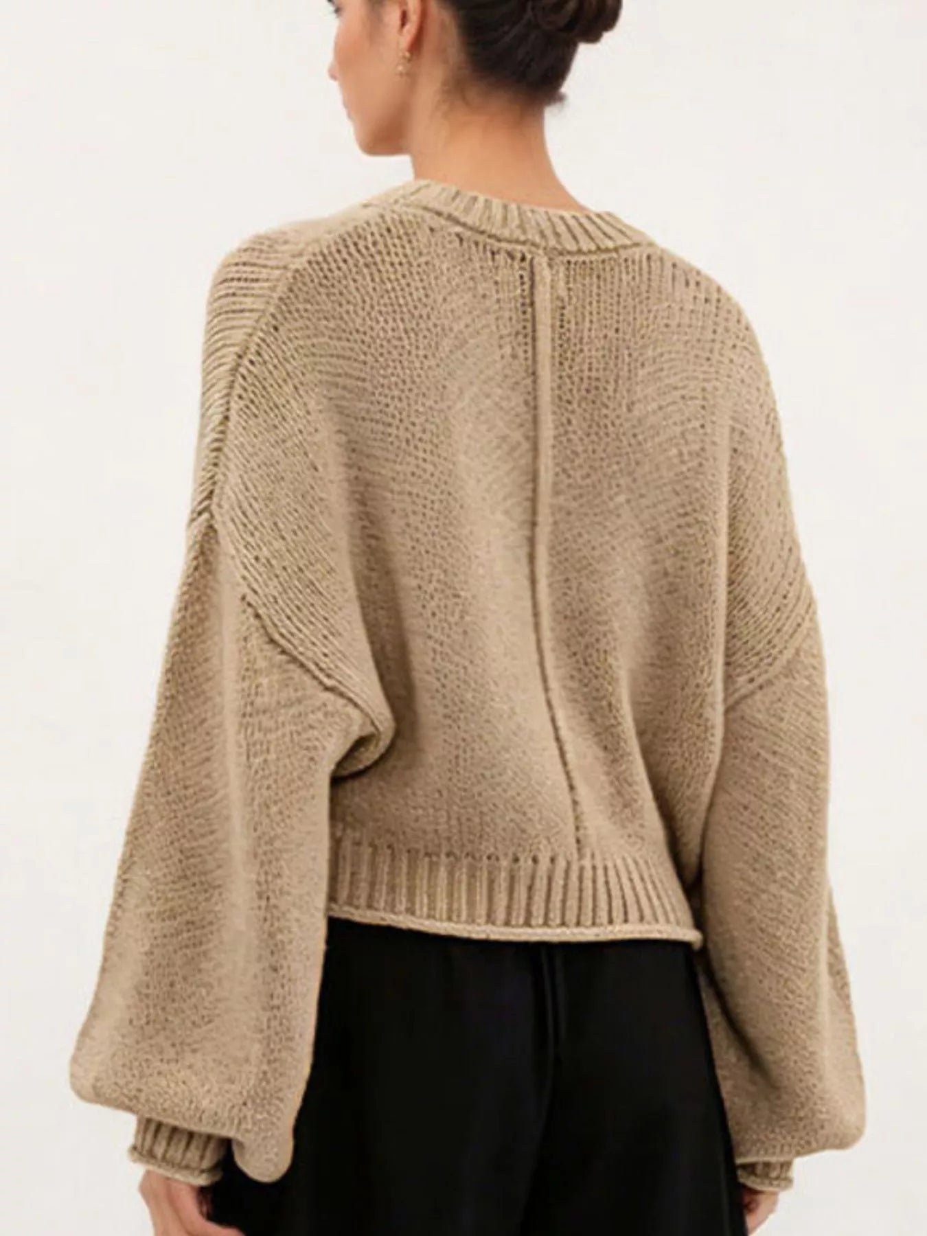 Back view of a khaki oversized chunky knit sweater with balloon sleeves