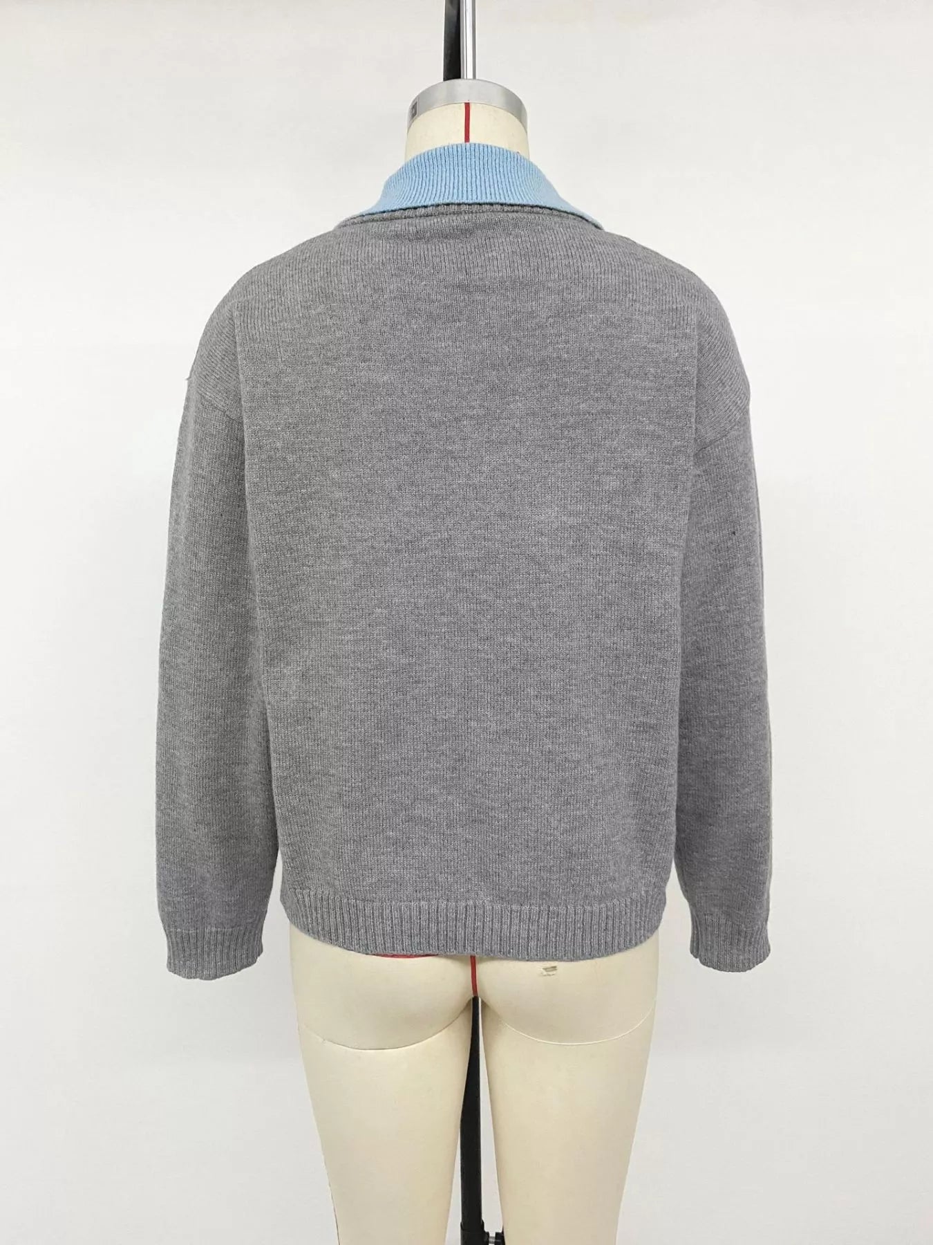 Back view of the gray contrast collar sweater displayed on a dress form