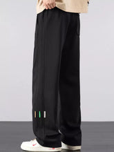 Men's casual loose fit pants with a drawstring waist and pockets.