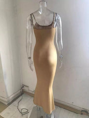 Back view of a camel spaghetti strap bodycon maxi dress on a clear mannequin showing thin shoulder straps