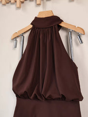 Brown halter mini dress on hanger, close view of gathered bodice and neckline