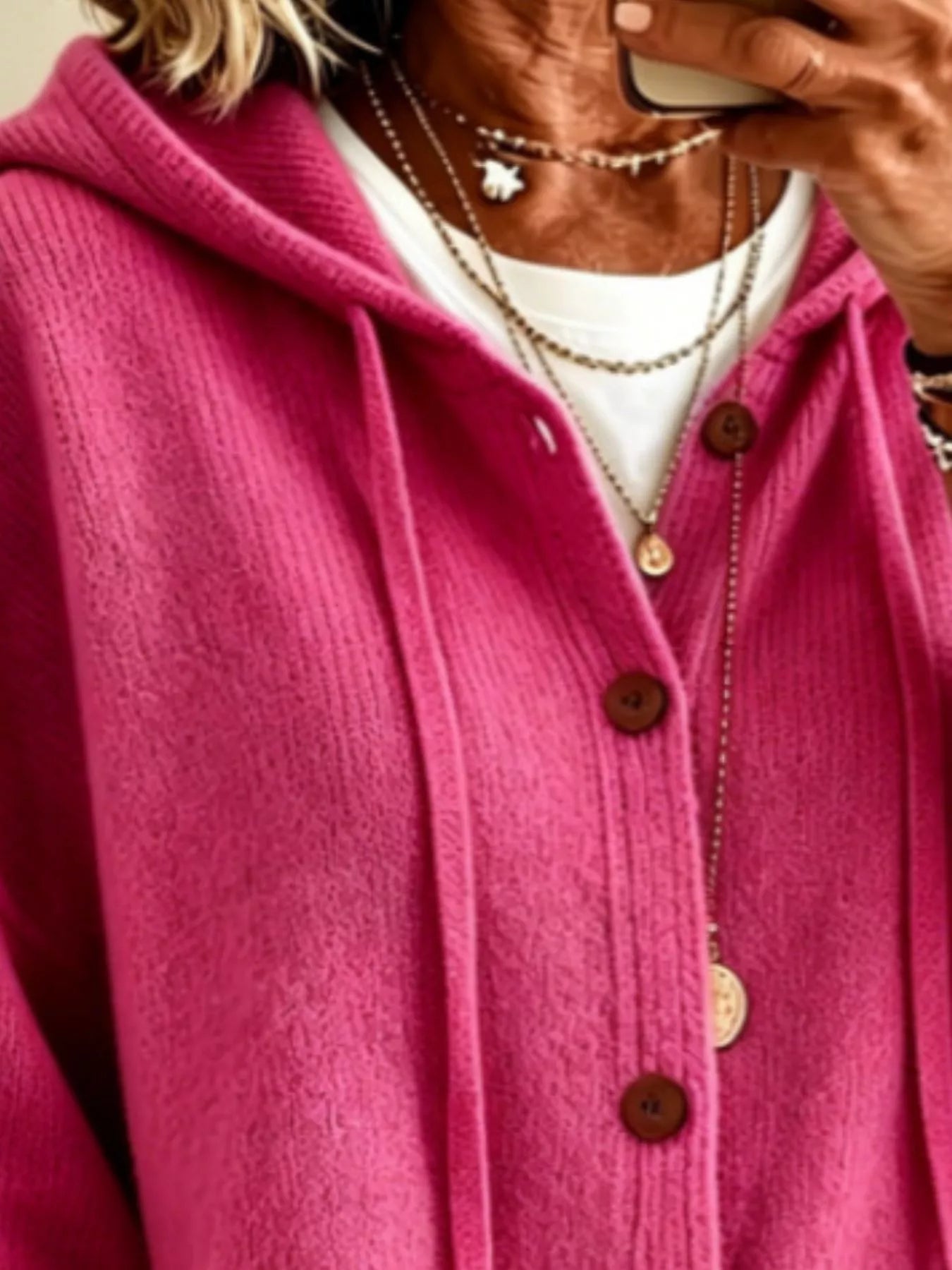 Close view of the fuchsia pink hooded cardigan showing drawstrings and button front