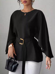 Black round neck blouse front view holding black handbag with gold buckle belt