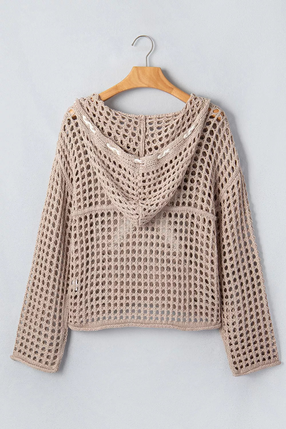 Back view of mocha openwork crochet hooded cover up with hood hanging on a hanger.