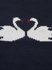 Close up of two facing white swans with red beaks on navy knit fabric