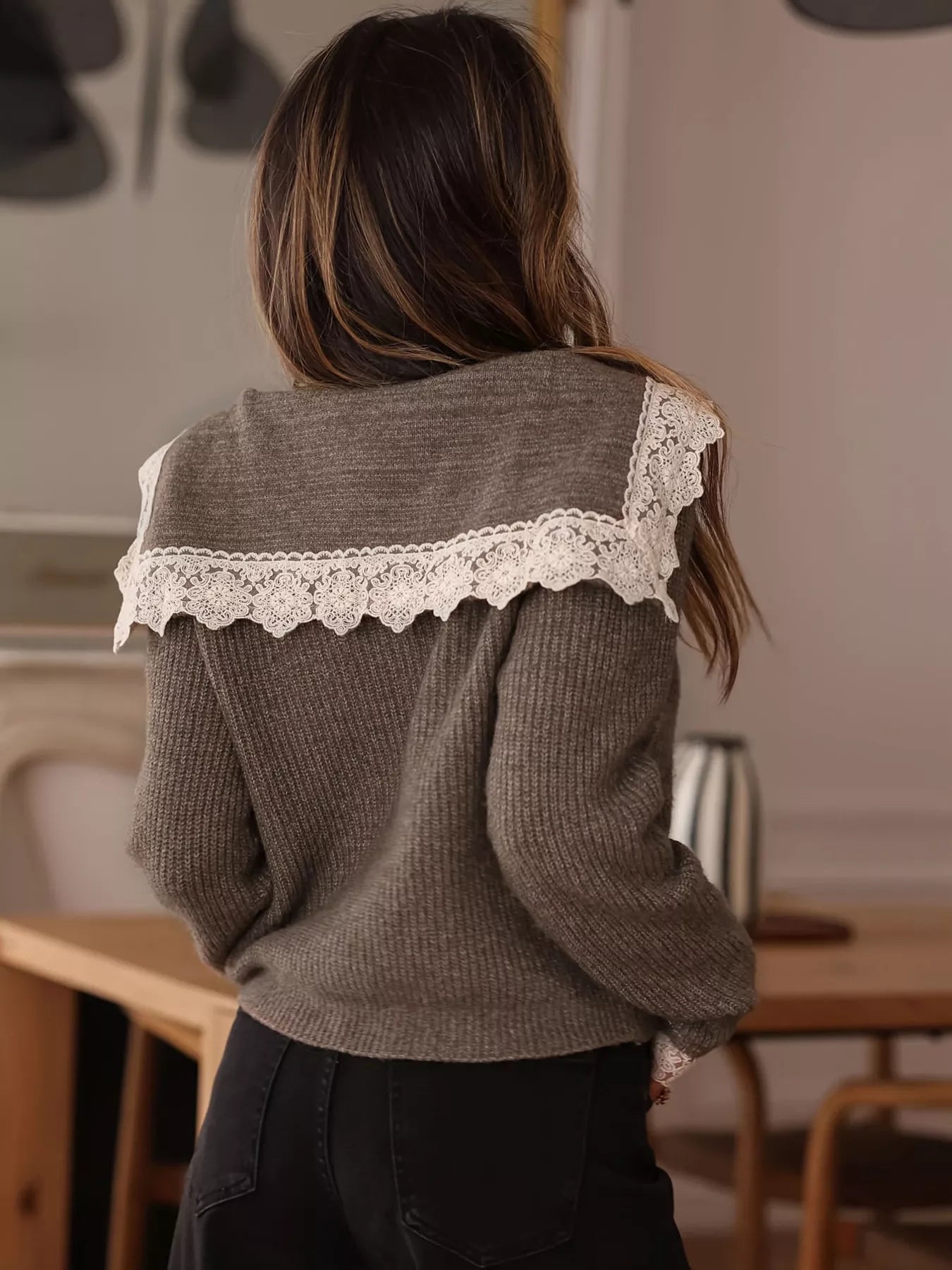 Back view of the brown cardigan with wide white lace collar detail