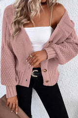 On-model front view of a dusty pink V-neck cardigan worn open over a white top