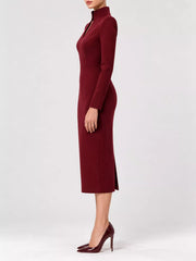Burgundy stand collar long sleeve midi dress in side profile showing hem slit and heels