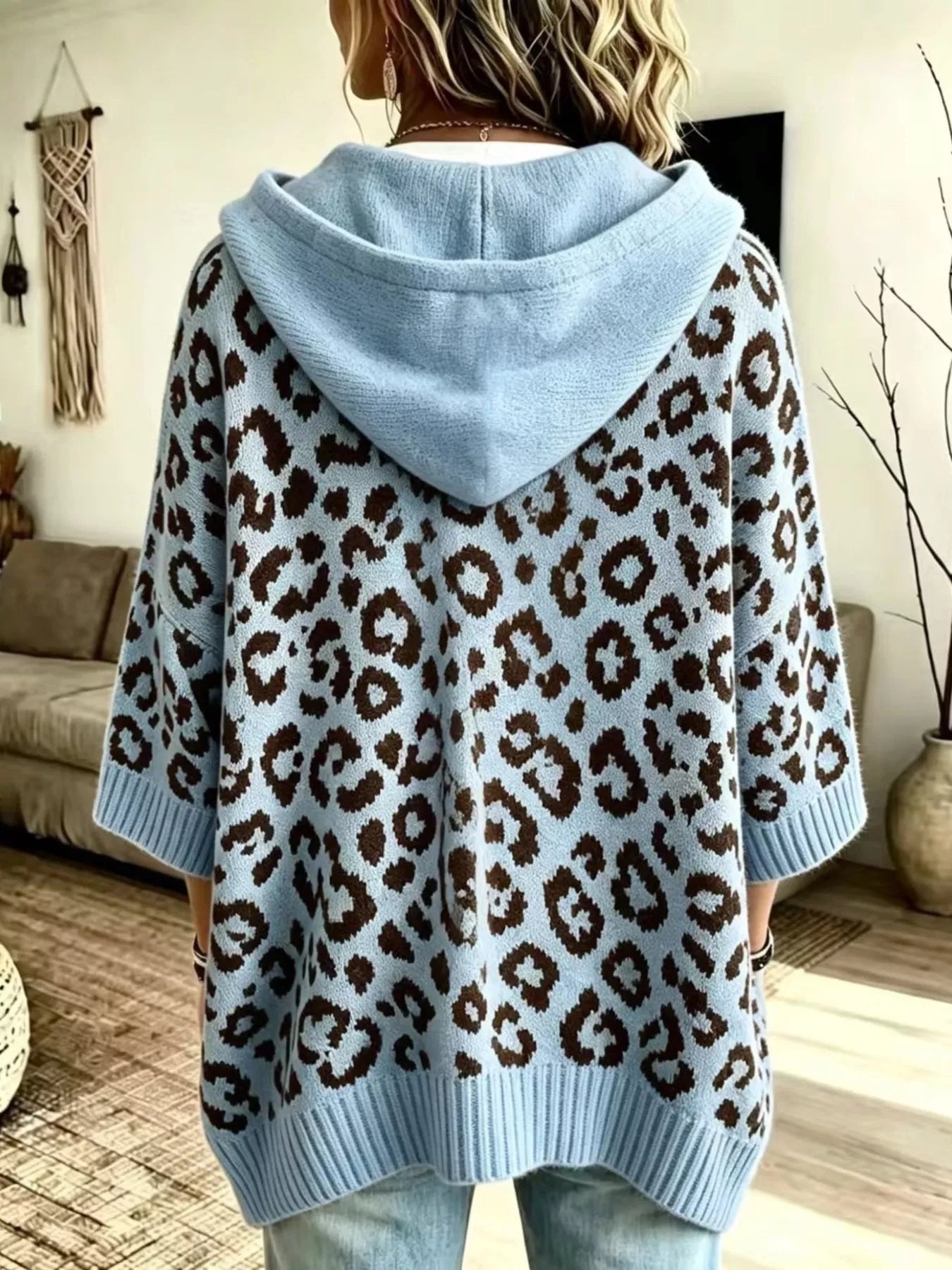 Back view of light blue leopard print oversized hooded knit sweater with solid blue hood