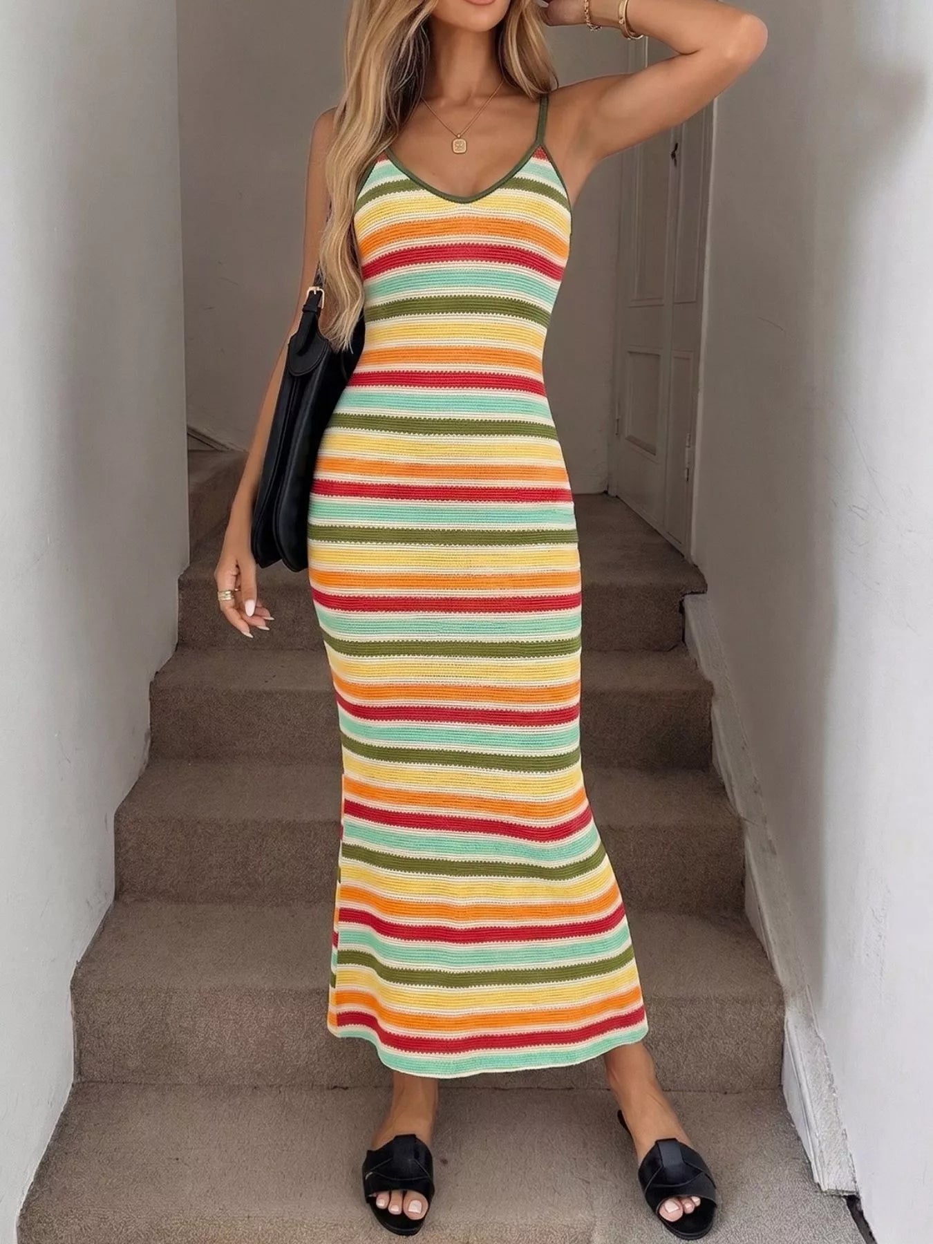 Front view of multicolor striped bodycon knit midi dress with bag over the shoulder