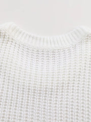 Close view of the back neckline of a white ribbed knit sweater showing knit texture.