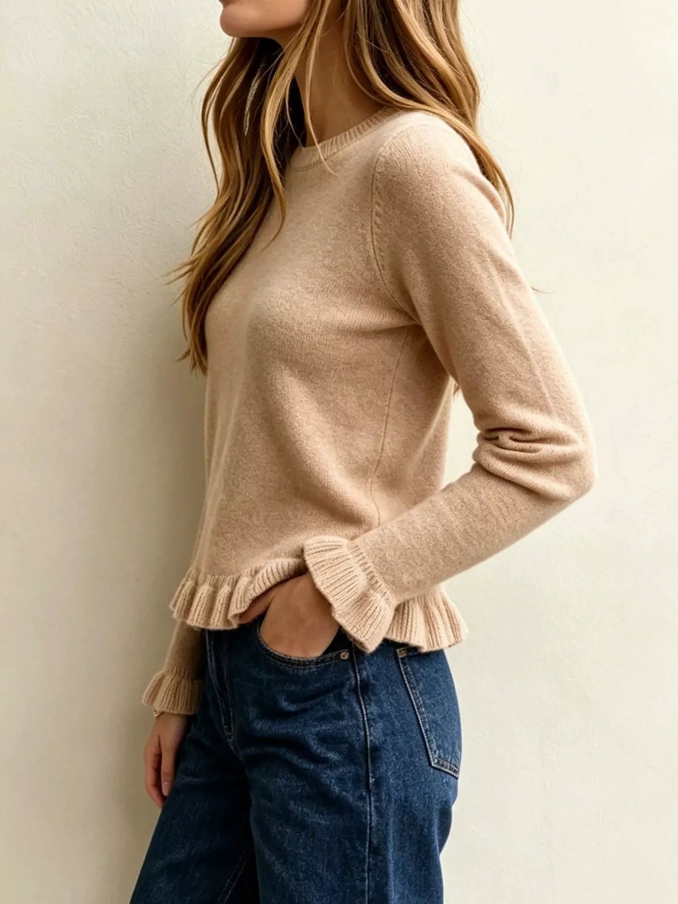 Side angle on-model view of khaki crew neck sweater with ruffled hem and cuffs