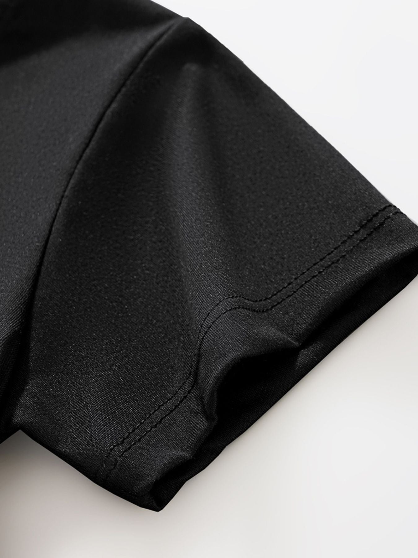 Close view of the short sleeve hem and double stitching on the black children's T-shirt