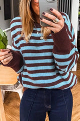 Cropped mirror selfie front view of the blue and brown striped sweater with brown cuffs