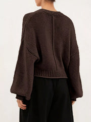 Back view of a brown oversized chunky knit sweater with balloon sleeves