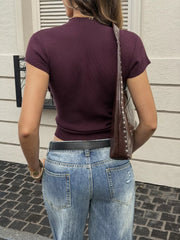 Back view of burgundy ribbed short sleeve knit top with light wash jeans