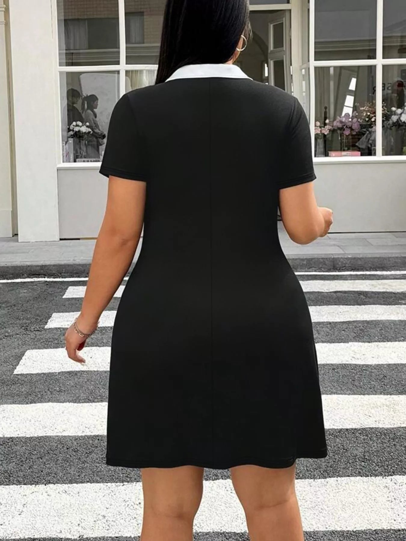 Back full view of black plus size mini dress with white collar