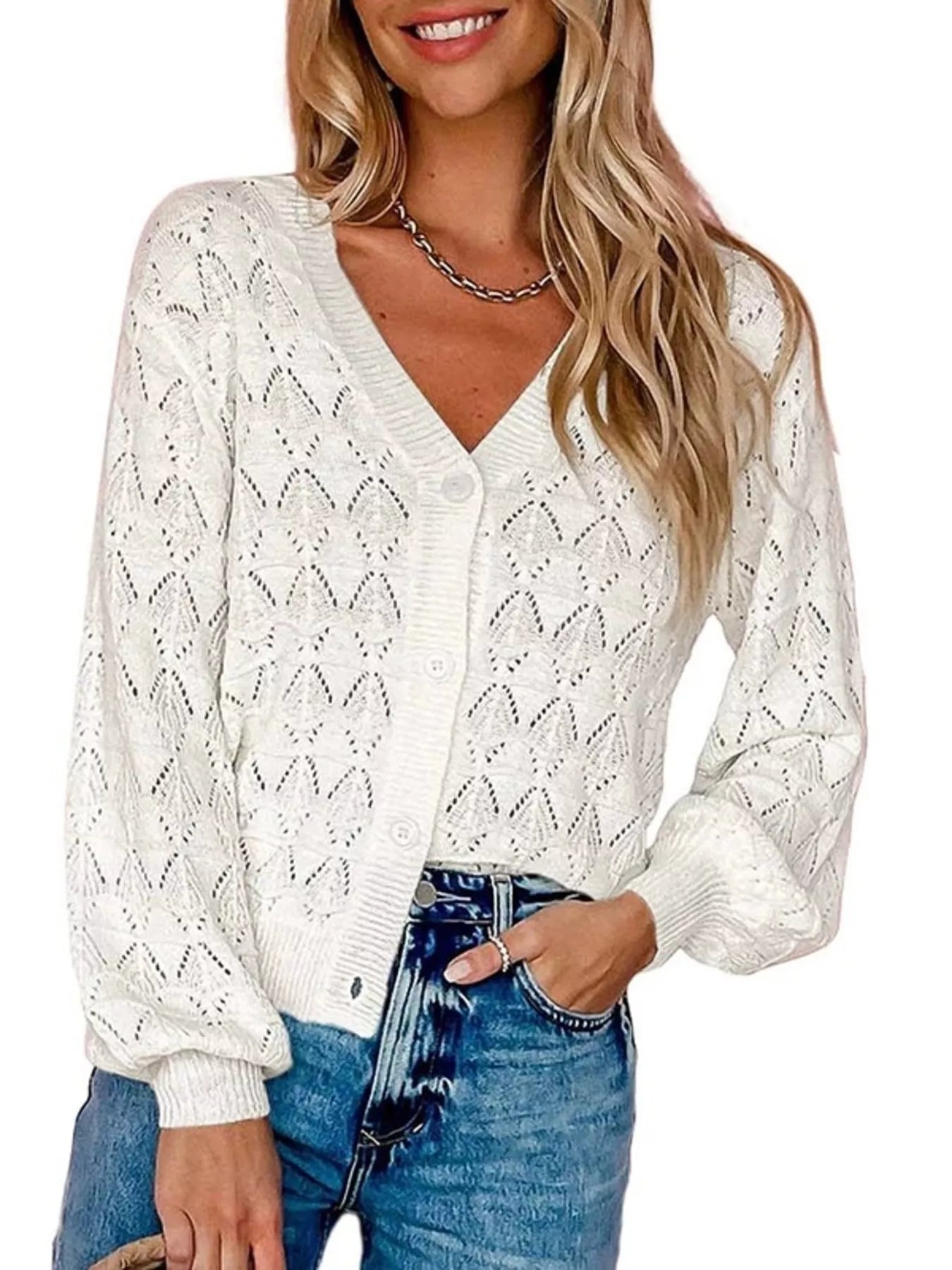 Front view of white openwork leaf knit cardigan with V neck and button front.
