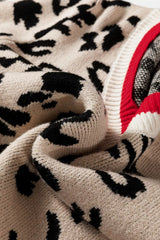 Close view of beige and black leopard knit fabric folded beside red ribbed trim.