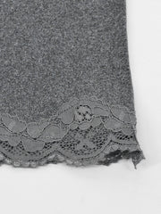 Close view of grey lace trim at the hem of the bodycon mini dress