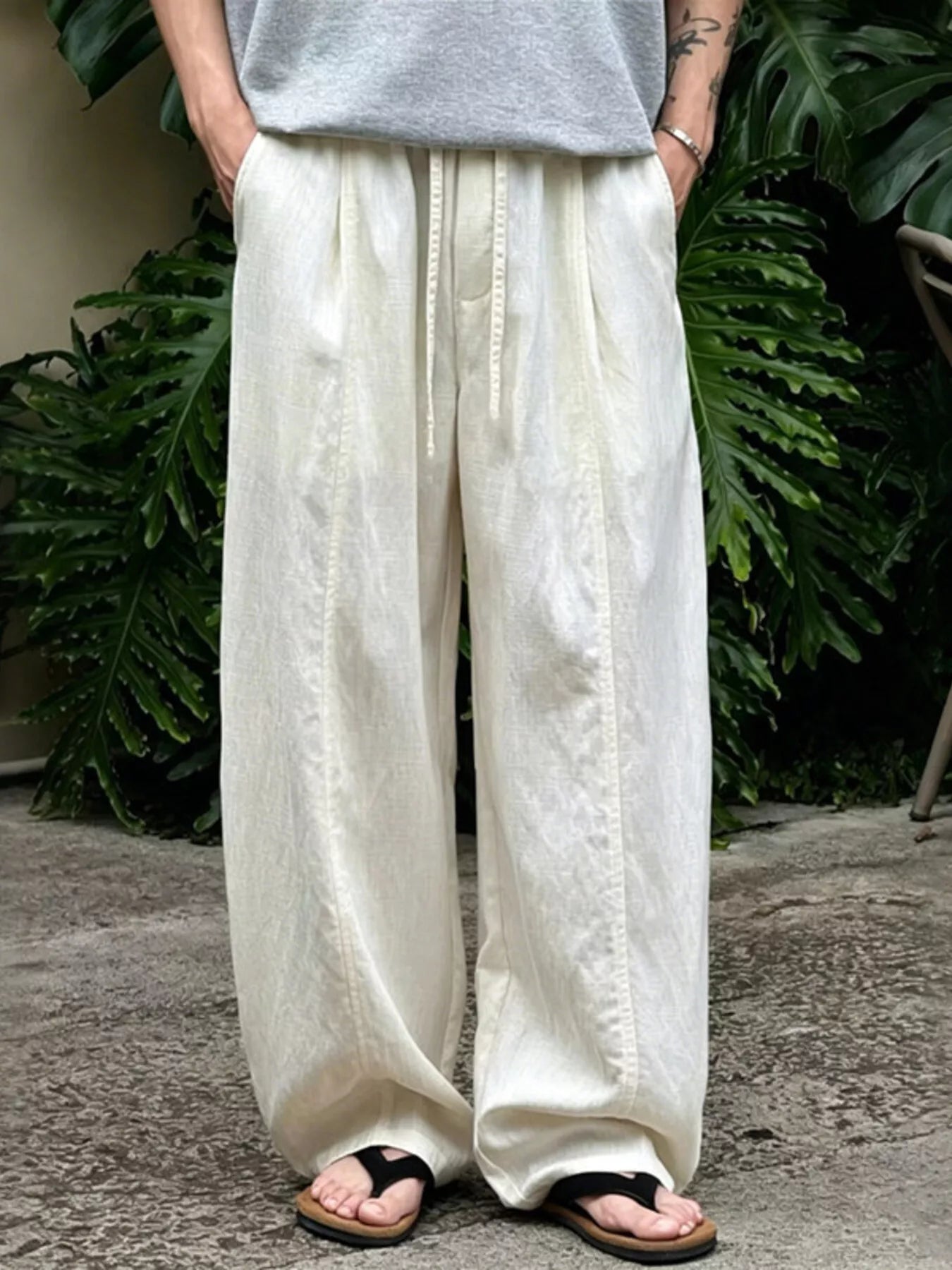 Men's wide-leg pants with a drawstring waist and pockets in the Flax color.