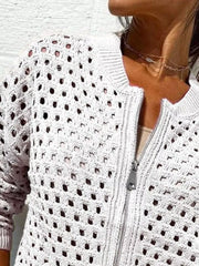 Close up of the white crochet cardigan upper zip and openwork pattern
