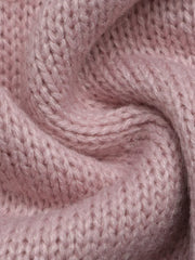 Close up showing the soft pink knit texture of the V neck sweater.
