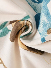 Close up of the folded cream fabric showing the blue and tan transportation print texture