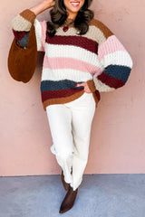 Full length view of multicolor striped knit sweater with white pants and boots