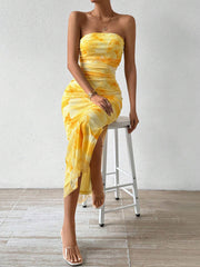 Yellow ruched strapless bodycon midi dress with side slit, seated view